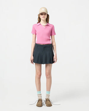 Close-up of Shrunken Polo in Rose detailing the three-button placket and signature branding at the neck.