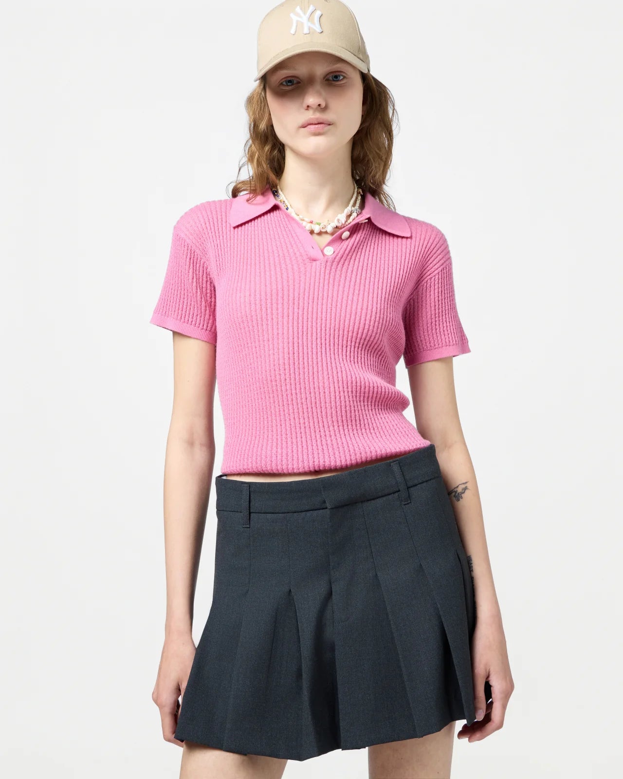 Back view of the Shrunken Polo in Rose emphasizing the signature branding at the neck.