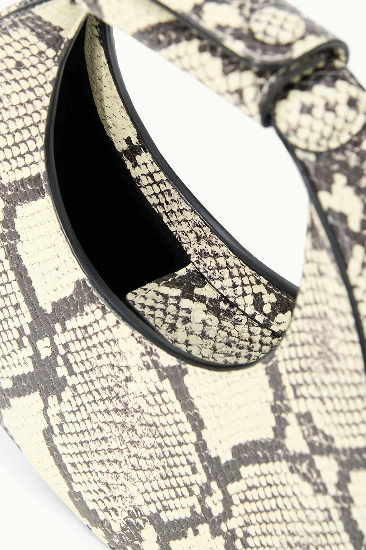 Fashion model carrying the Goodnight Moon Bag in White Snake, showcasing its versatility as an evening bag.