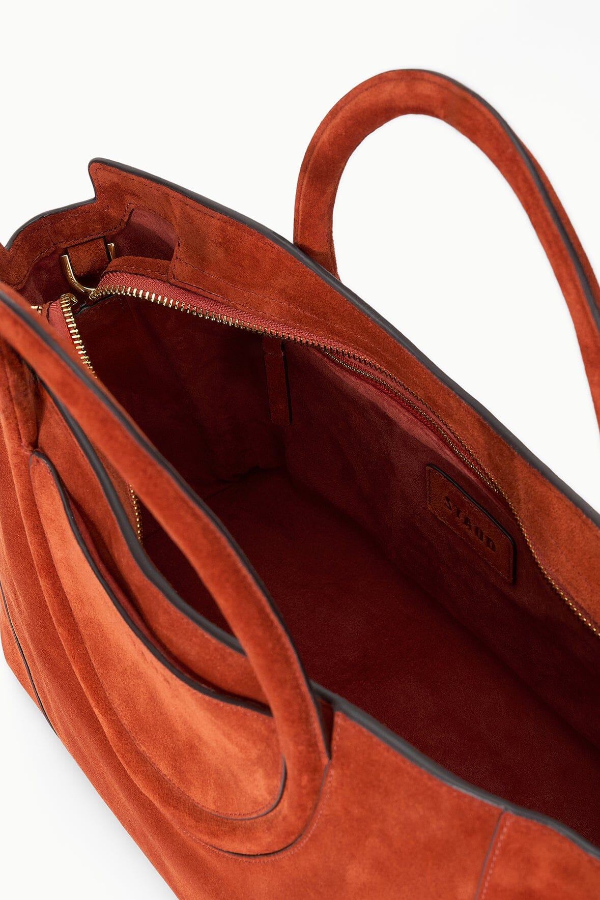 Maude Satchel in Auburn Suede displayed against a neutral background.