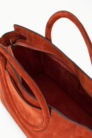 Maude Satchel in Auburn Suede displayed against a neutral background.