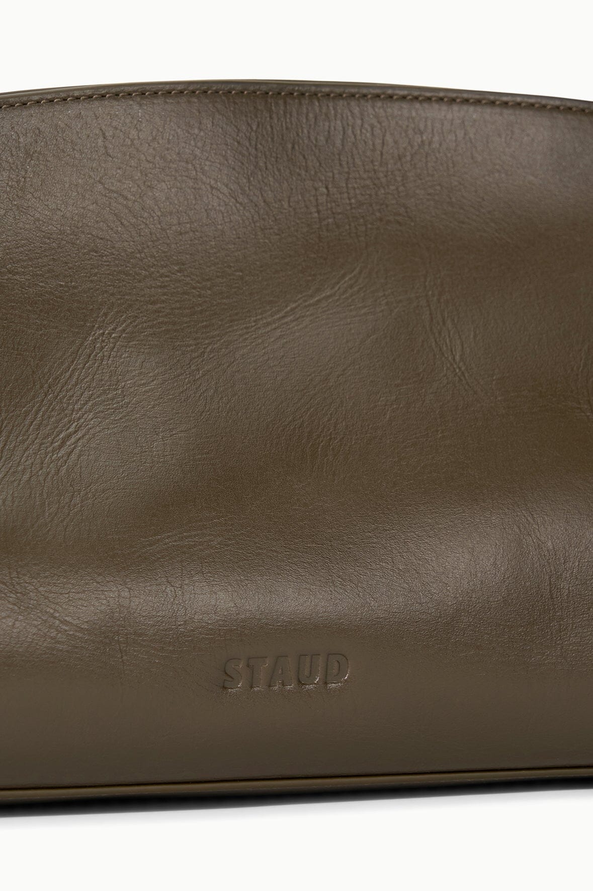 The Maude Soft Clutch in Truffle elegantly styled in a lifestyle setting, ideal for fashion lovers.