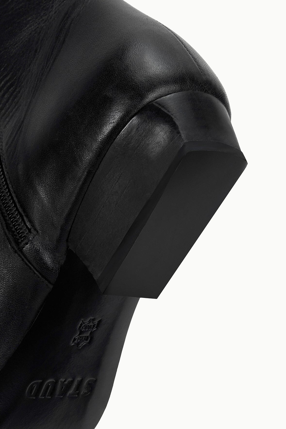 Wally Flat Ankle Boot in Black by Staud, highlighting the ankle height and sophisticated appearance.