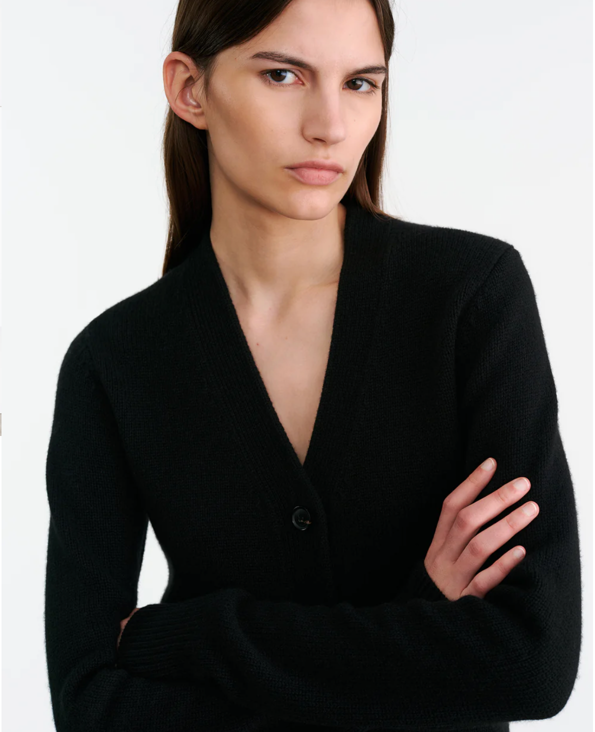 Flat lay of the Charmaine Cashmere Cardigan in Black, displaying its elegant jersey stitch pattern and horn buttons.