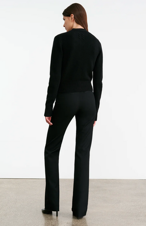 Back view of the Charmaine Cashmere Cardigan in Black, showing off the unique center back cable knit design.