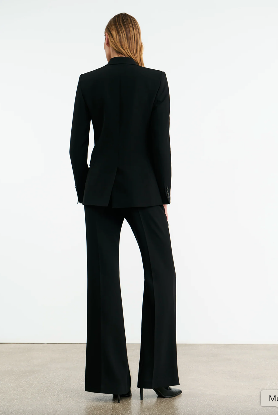 Side view of the Anabel Tailored Jacket in Black featuring full length sleeves and chest piece detailing.