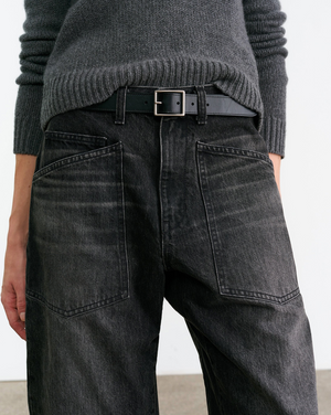 Nili Lotan Shon Jean in Stone Black Wash displayed on a mannequin, emphasizing the mid-rise and barrel leg design.