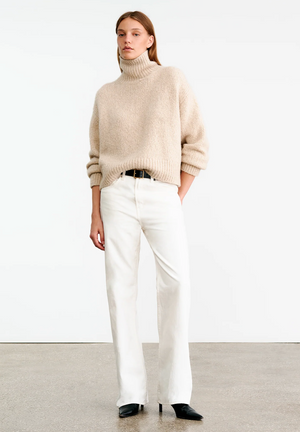 Close-up of Tabitha Sweater in Beige Melange highlighting the ribbed hem and sleeves.