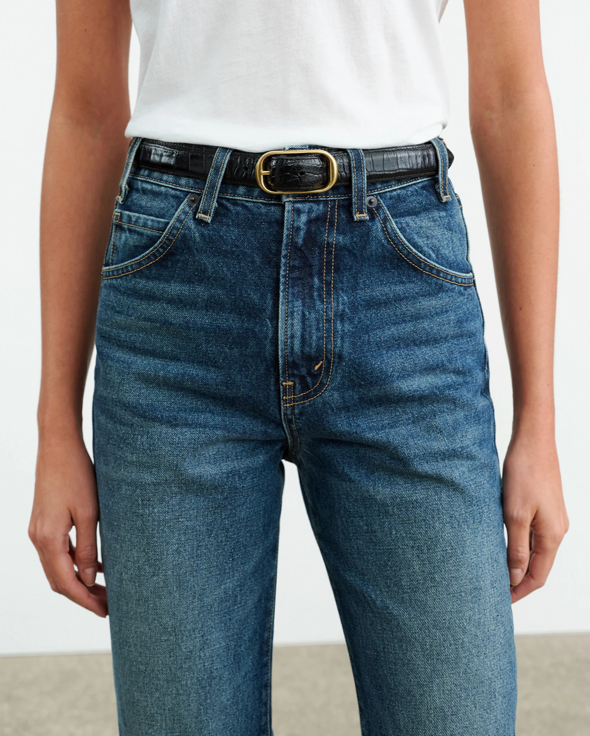Flat lay of Nili Lotan Joan Jean in Classic Wash with a stylish arrangement, showcasing its 100% cotton composition.