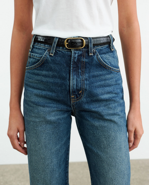 Flat lay of Nili Lotan Joan Jean in Classic Wash with a stylish arrangement, showcasing its 100% cotton composition.