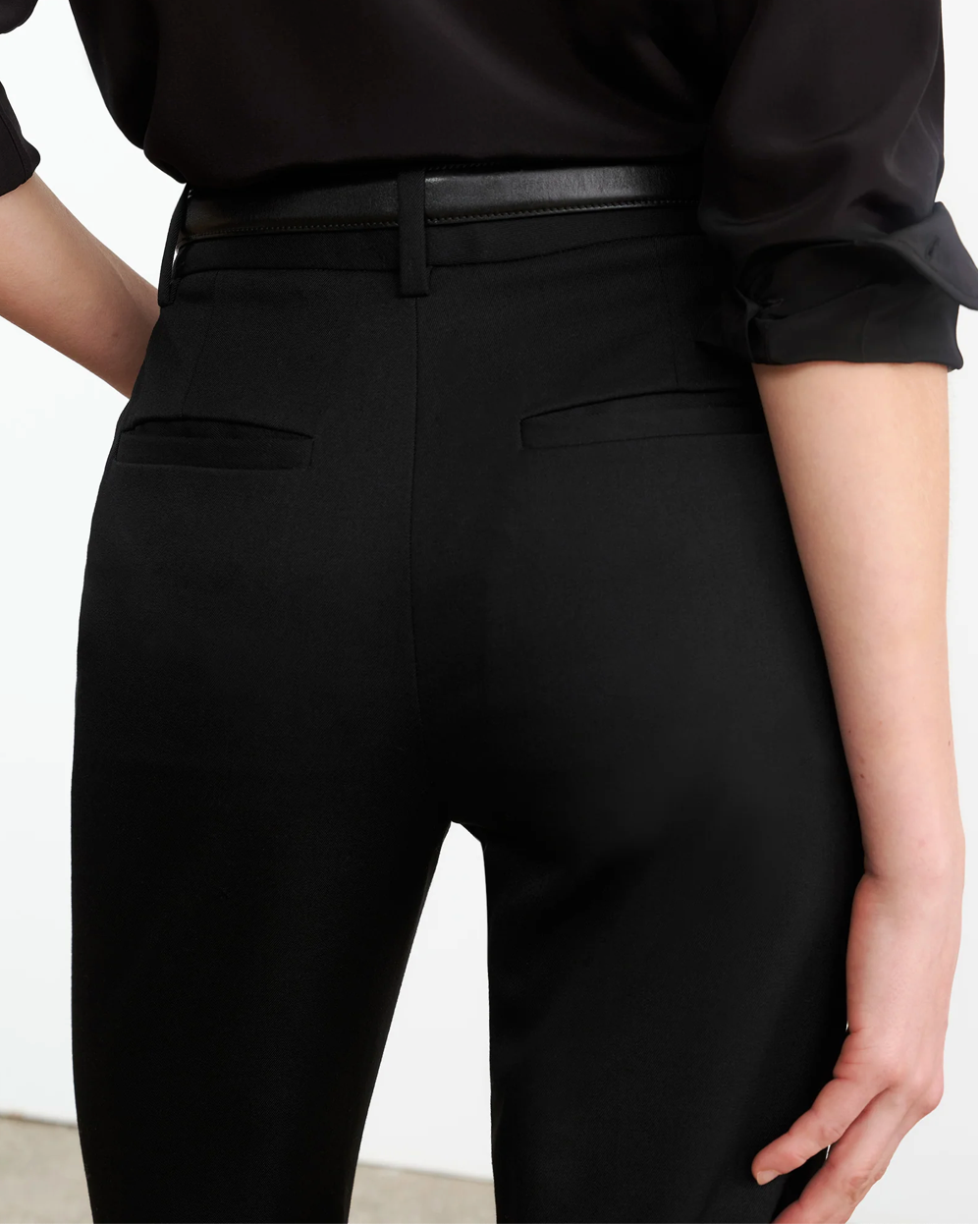 Flat lay of the Corette Pant in Black by Nili Lotan, highlighting its sleek lines and elegant black color.