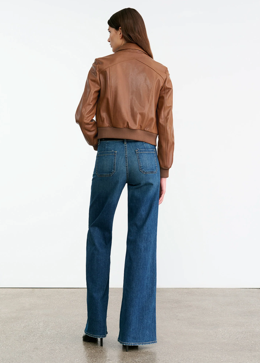 Model wearing the Sue Leather Jacket in Cognac, featuring a chic silhouette and functional pockets.