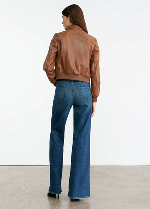Model wearing the Sue Leather Jacket in Cognac, featuring a chic silhouette and functional pockets.