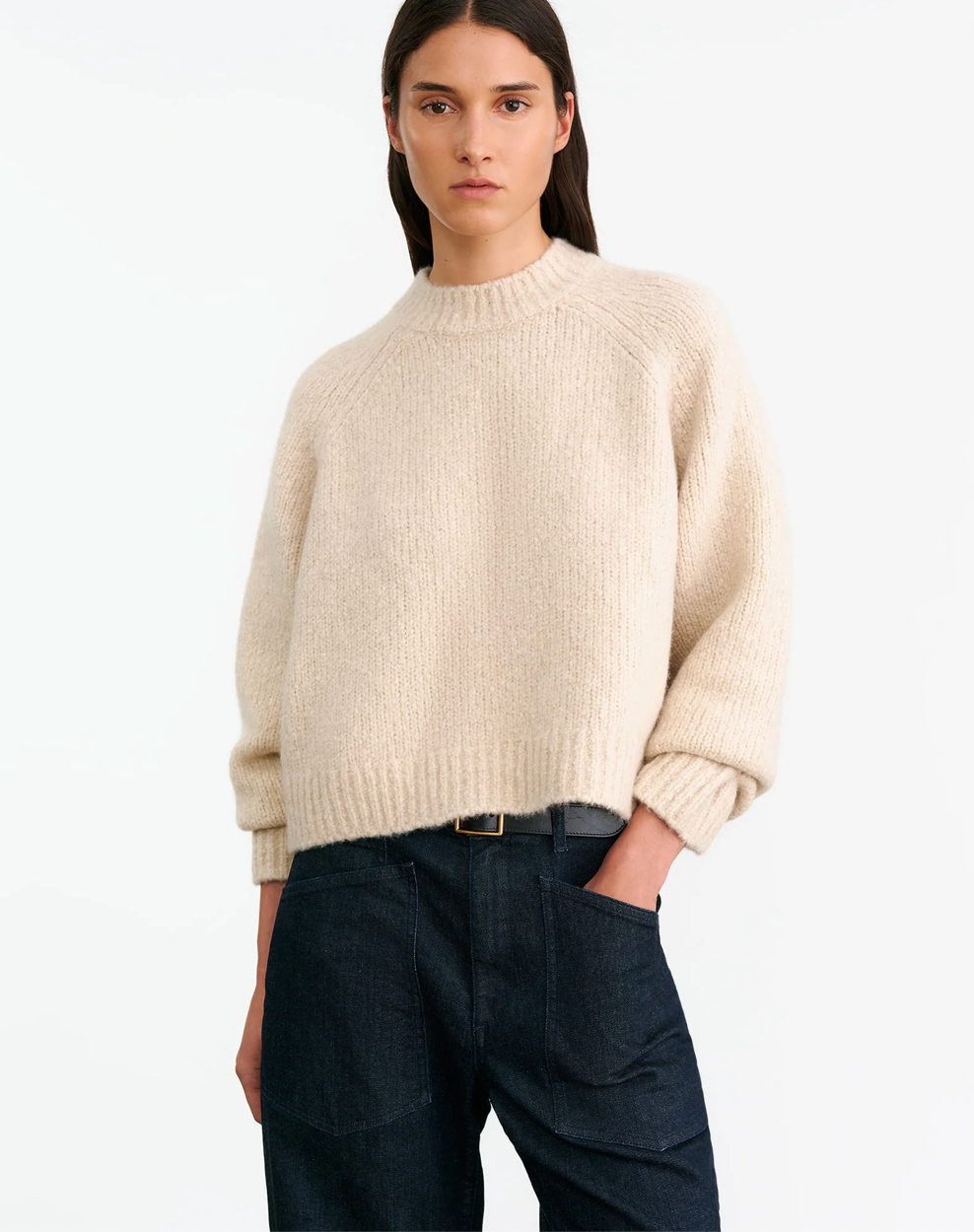 Back view of Tomaso Sweater in Beige Melange showcasing the signature cable knit detail along the center.