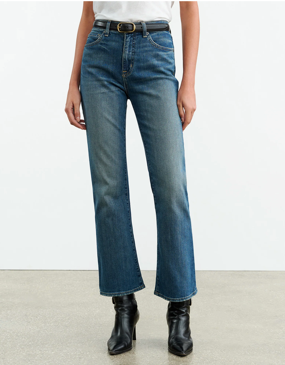 Model wearing Nili Lotan Boot Cut Jean in Classic Wash, highlighting the fitted waist and hips.