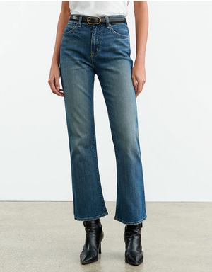 Model wearing Nili Lotan Boot Cut Jean in Classic Wash, highlighting the fitted waist and hips.