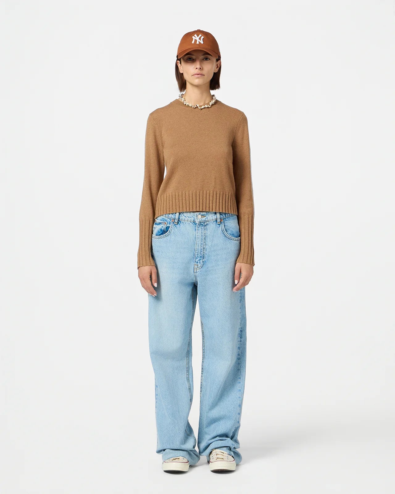 Close-up of Shrunken Crew in Almond showcasing soft cashmere texture and signature branding.