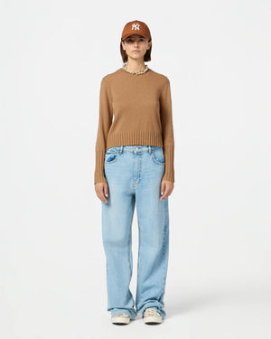 Close-up of Shrunken Crew in Almond showcasing soft cashmere texture and signature branding.