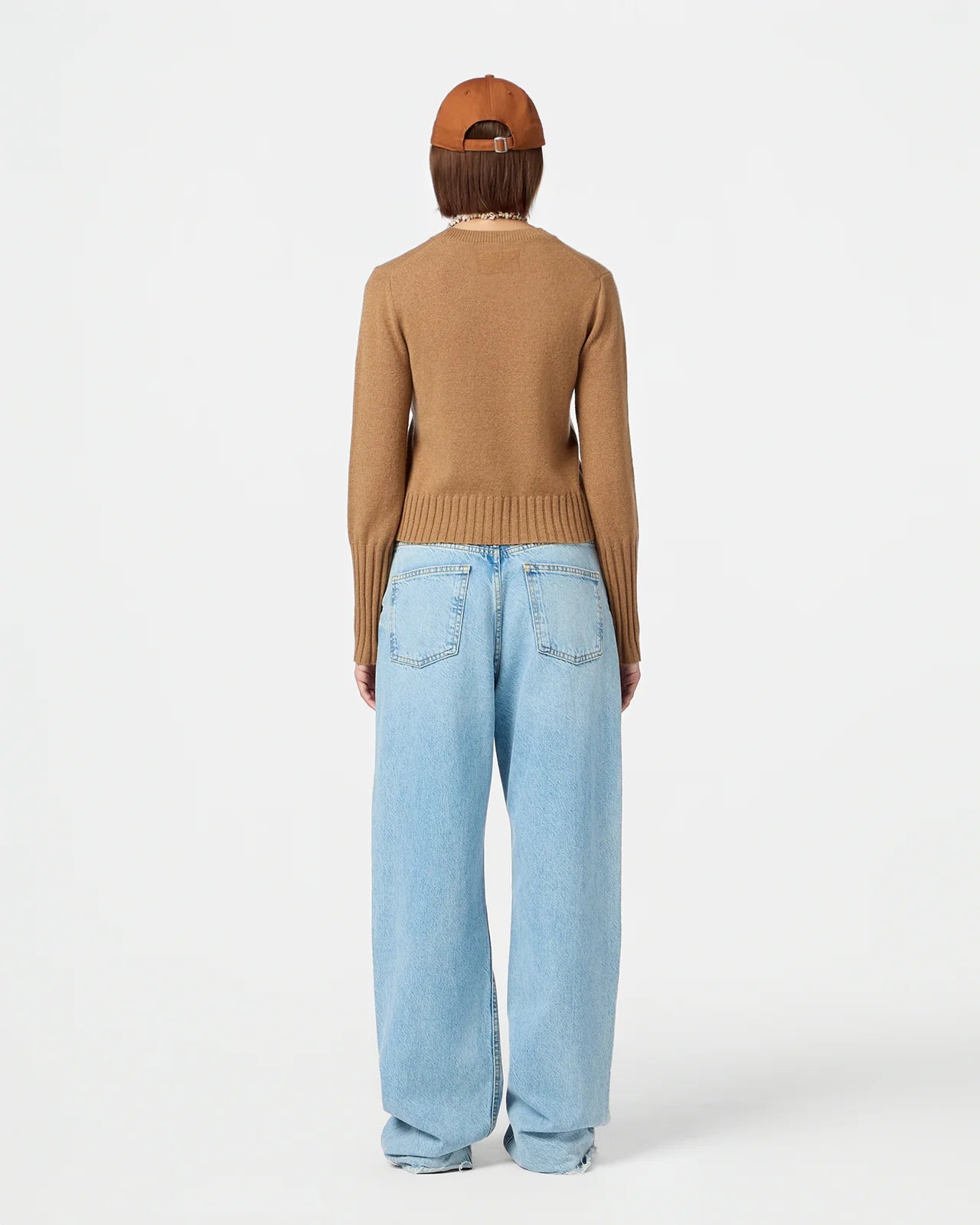Back view of Shrunken Crew in Almond emphasizing rib trim hem and branding.