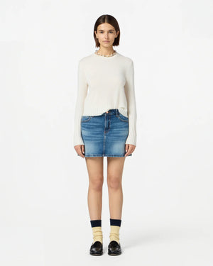 Close-up of Shrunken Crew in Cream, showcasing soft 100% cashmere fabric and ribbed sleeve cuffs.