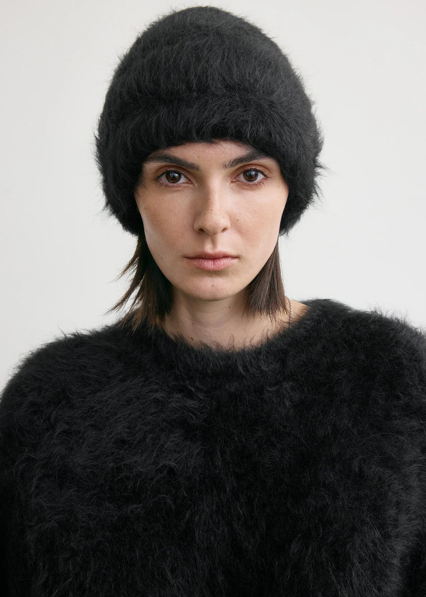 Close-up of the Alpaca Beanie Hat in Black by TOTEME, highlighting its fuzzy texture and quality knit.