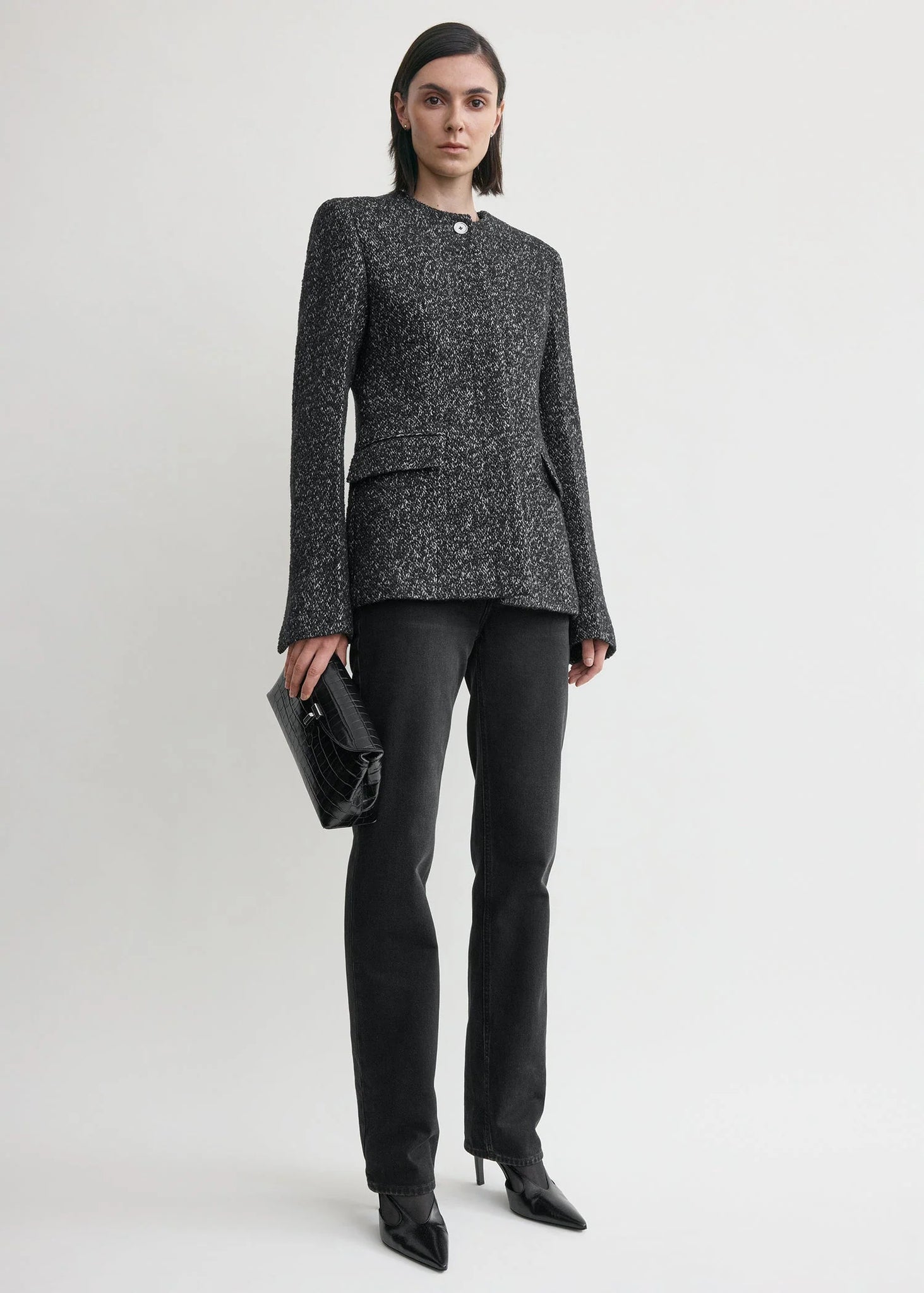 Close-up of the Collarless Cinched Jacket in Black/White highlighting the slim silhouette and collarless neck.