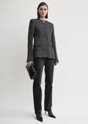 Close-up of the Collarless Cinched Jacket in Black/White highlighting the slim silhouette and collarless neck.