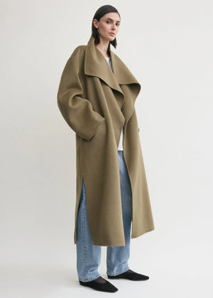 Model wearing the TOTEME Signature Doublé Coat in Hazel draped over an evening dress, showcasing its elegant open front.