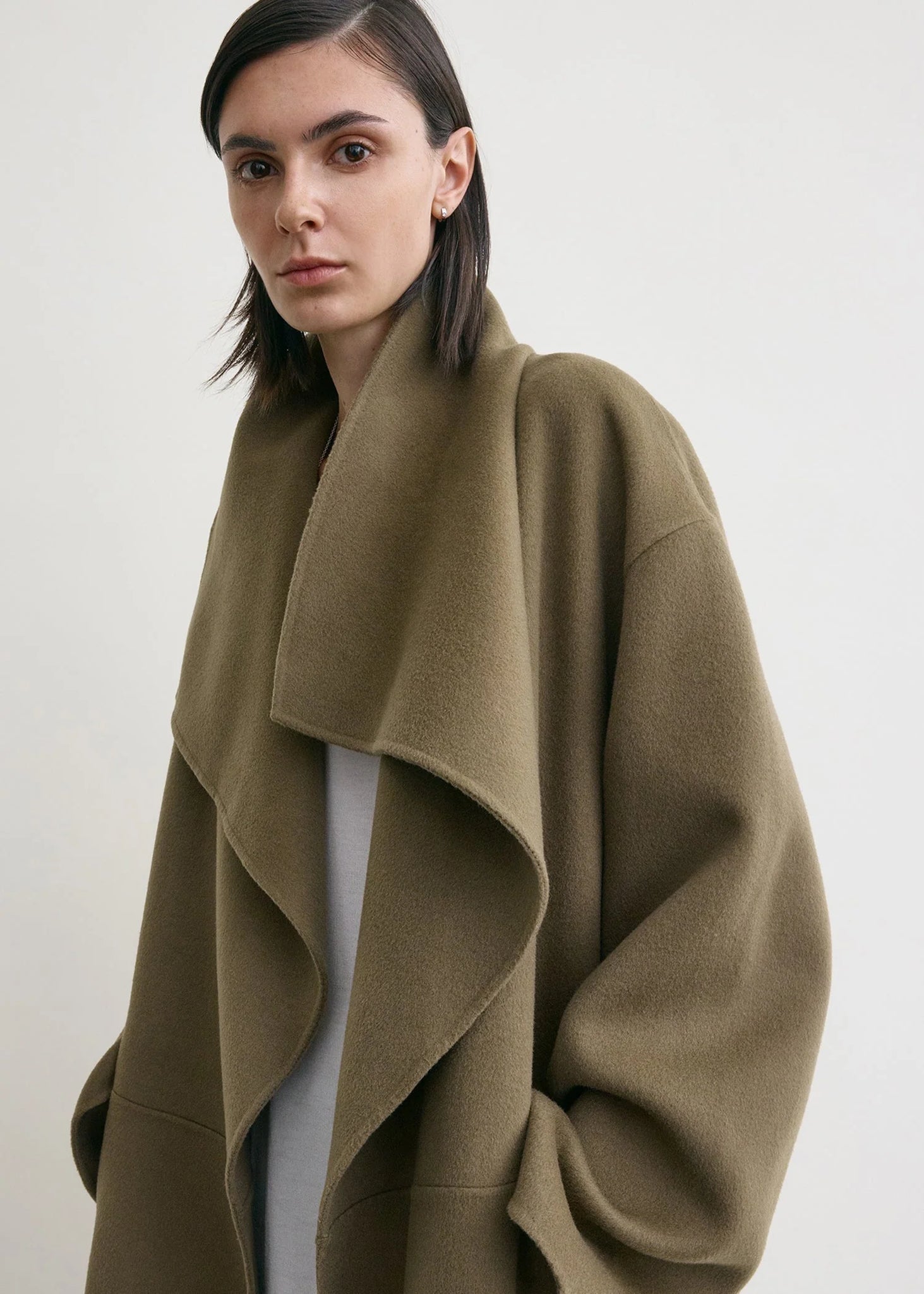 Casual presentation of the TOTEME Signature Doublé Coat in Hazel, perfect for layering over cozy knits.
