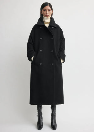 Side view of the Shield Coat in Black by TOTEME, showcasing its clean collar and cozy wool blend.