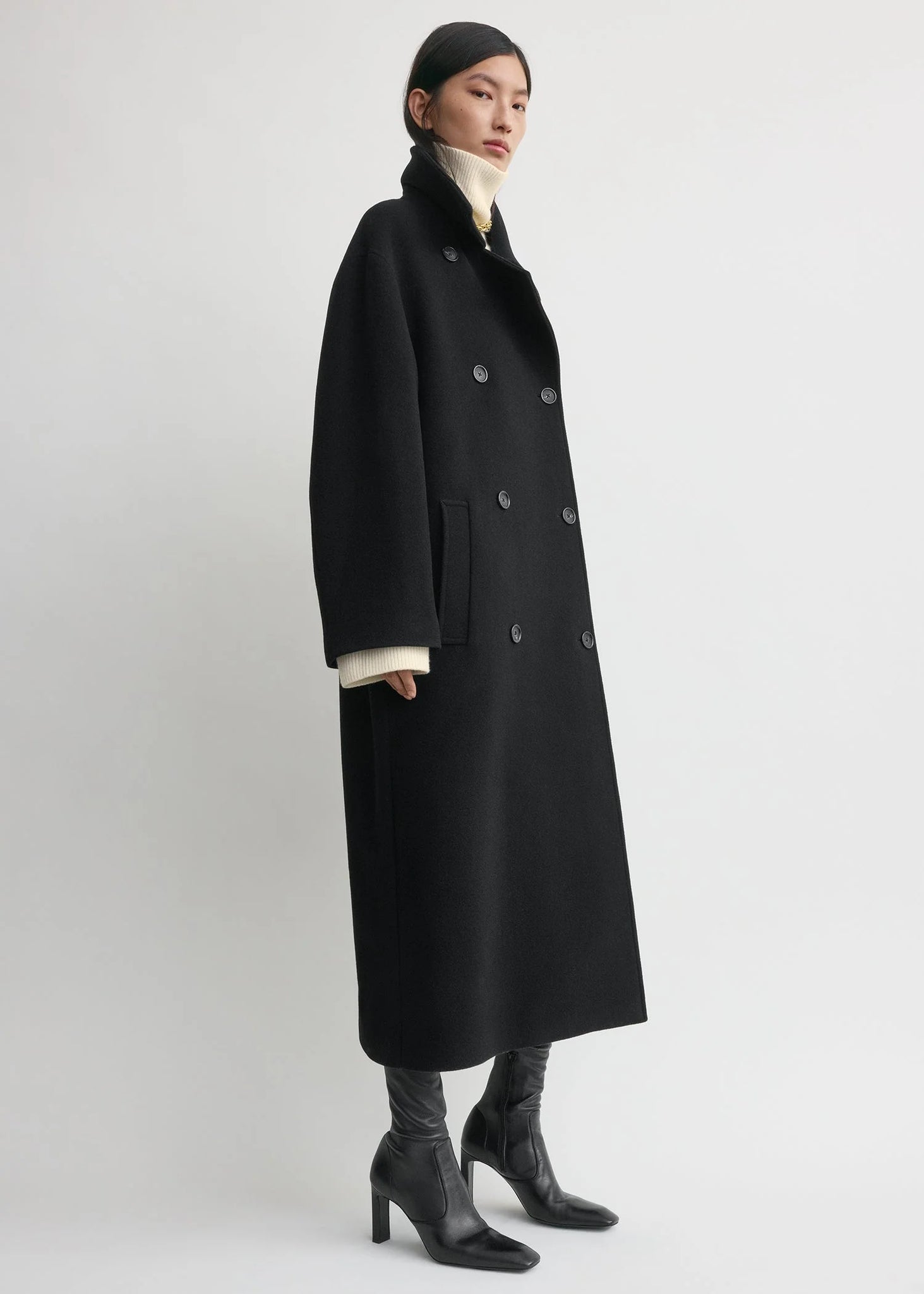 Close-up of the fabric of the Shield Coat in Black by TOTEME, highlighting the brushed wool blend and recycled materials.