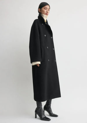 Close-up of the fabric of the Shield Coat in Black by TOTEME, highlighting the brushed wool blend and recycled materials.
