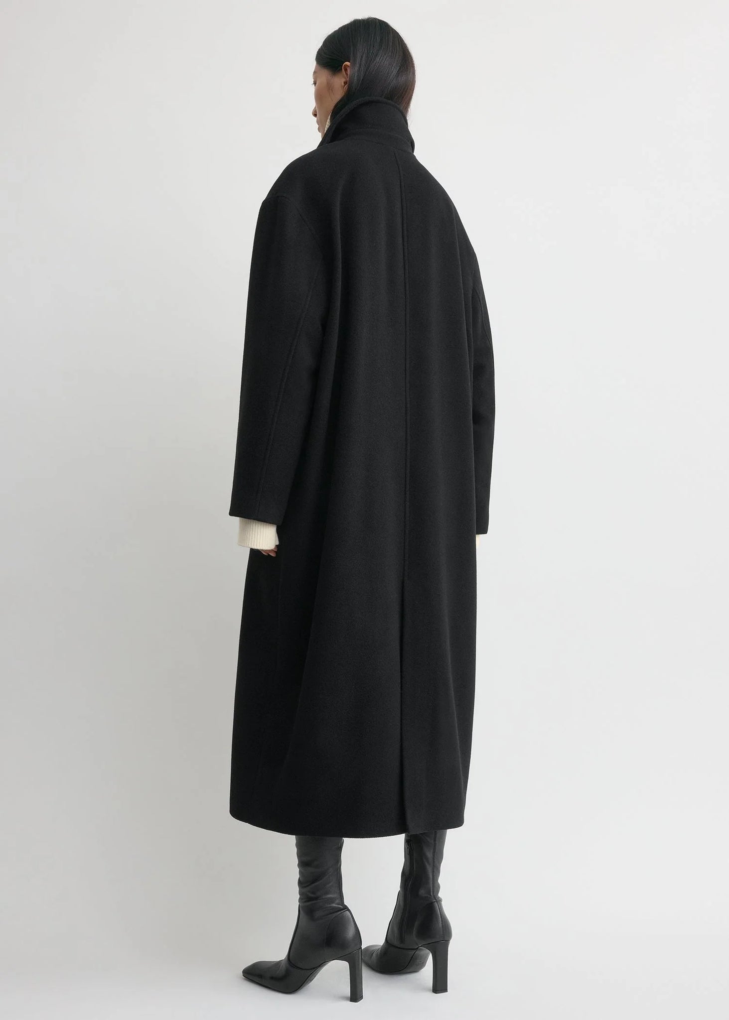 Back view of the Shield Coat in Black by TOTEME, illustrating its modern oversized design.