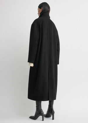 Back view of the Shield Coat in Black by TOTEME, illustrating its modern oversized design.