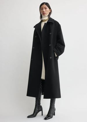 Full outfit shot with the Shield Coat in Black by TOTEME, showing how to style it for cold weather.