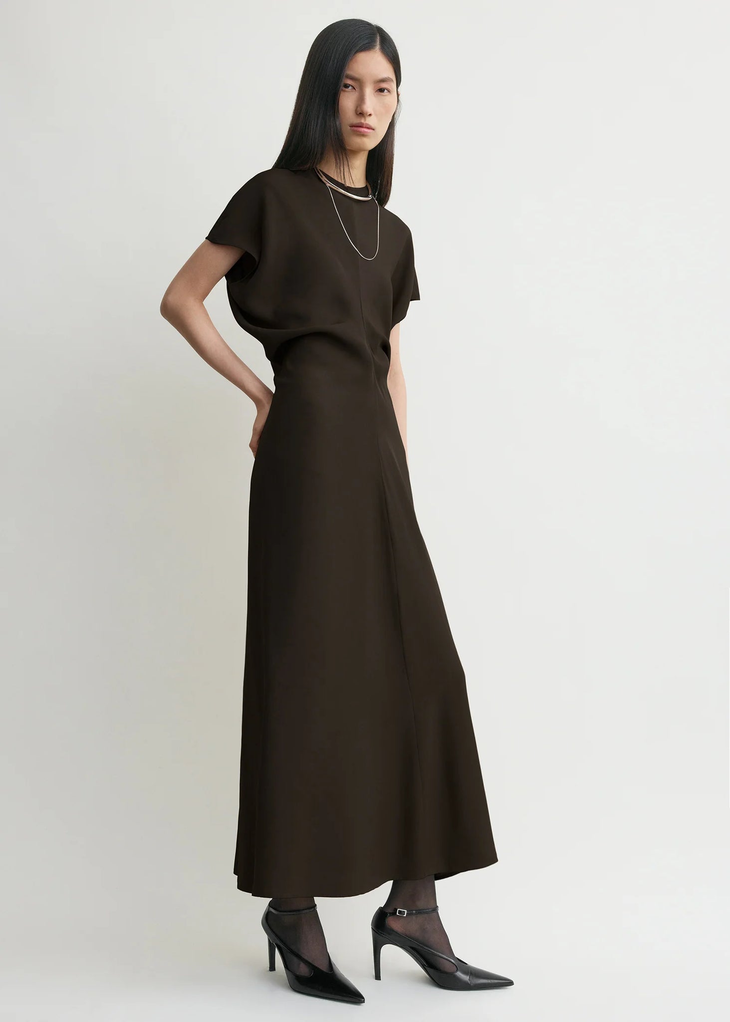 Full view of TOTEME Slouch Waist Dress in Bark, highlighting its lustrous satin reverse and floor-grazing hem.