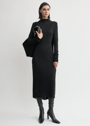 Close-up view of the Cocoon Cape Dress in Black by TOTEME, showcasing its low-cut back and sleek jersey fabric.