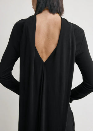 Cocoon Cape Dress in Black by TOTEME styled with tonal accessories, perfect for an elegant night out.