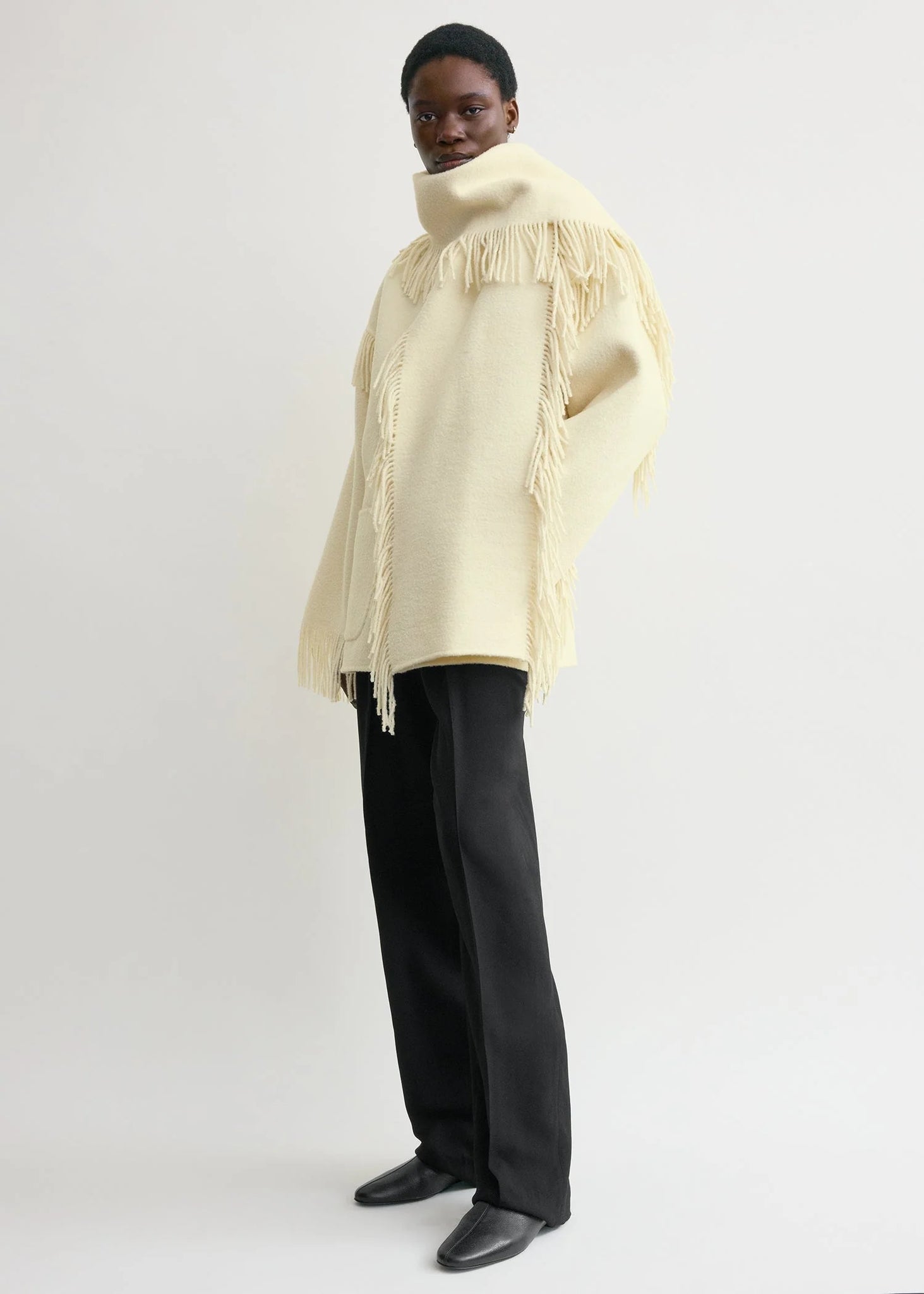 Back view of the Fringed Scarf Jacket in Winter White by TOTEME, displaying the boxy cut and stylish scarf collar.