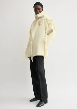 Back view of the Fringed Scarf Jacket in Winter White by TOTEME, displaying the boxy cut and stylish scarf collar.