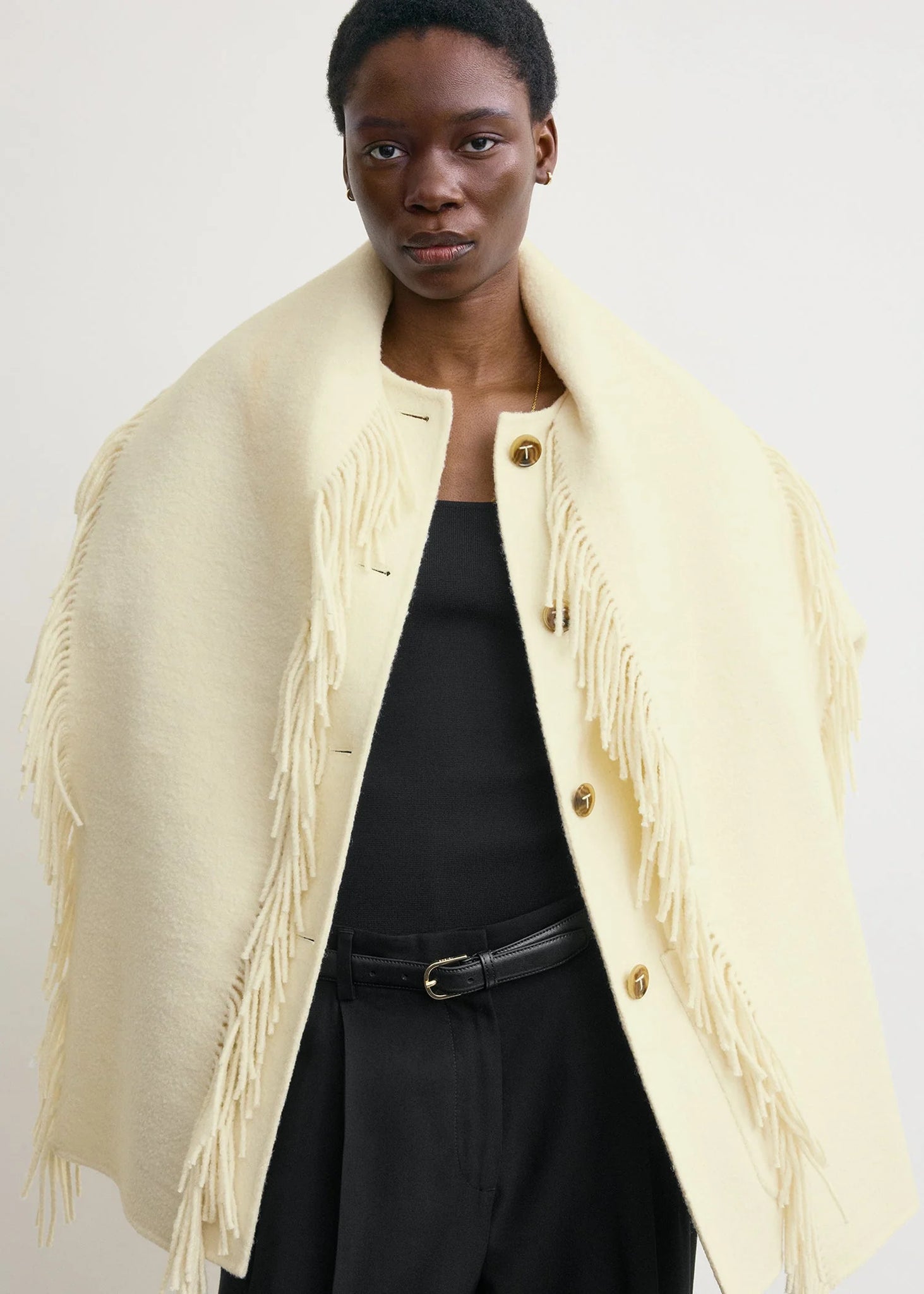 Side view of the Fringed Scarf Jacket in Winter White, emphasizing the patch pockets and trendy design.