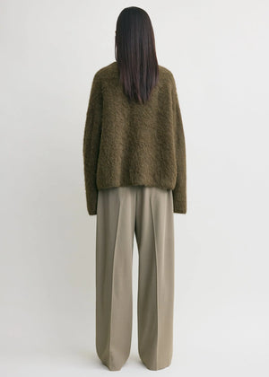Model wearing the Boxy Alpaca Knit in Pepper styled with tailored trousers, perfect for a chic office look.