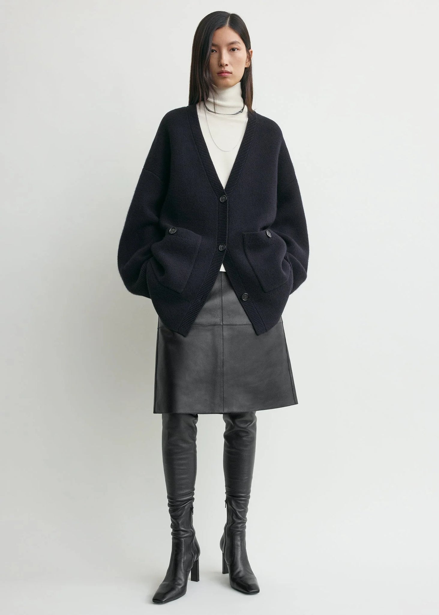 The cozy Longline Cardigan in Navy by TOTEME with double-knitted fabric and spacious patch pockets.