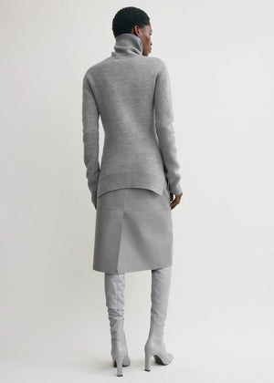 Model wearing the High-neck Double Knit Sweater in Pale Grey Melange paired with an A-line skirt.