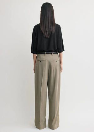 Side profile of the Wide Fluid Trousers in Taupe demonstrating the generous leg drape by TOTEME.