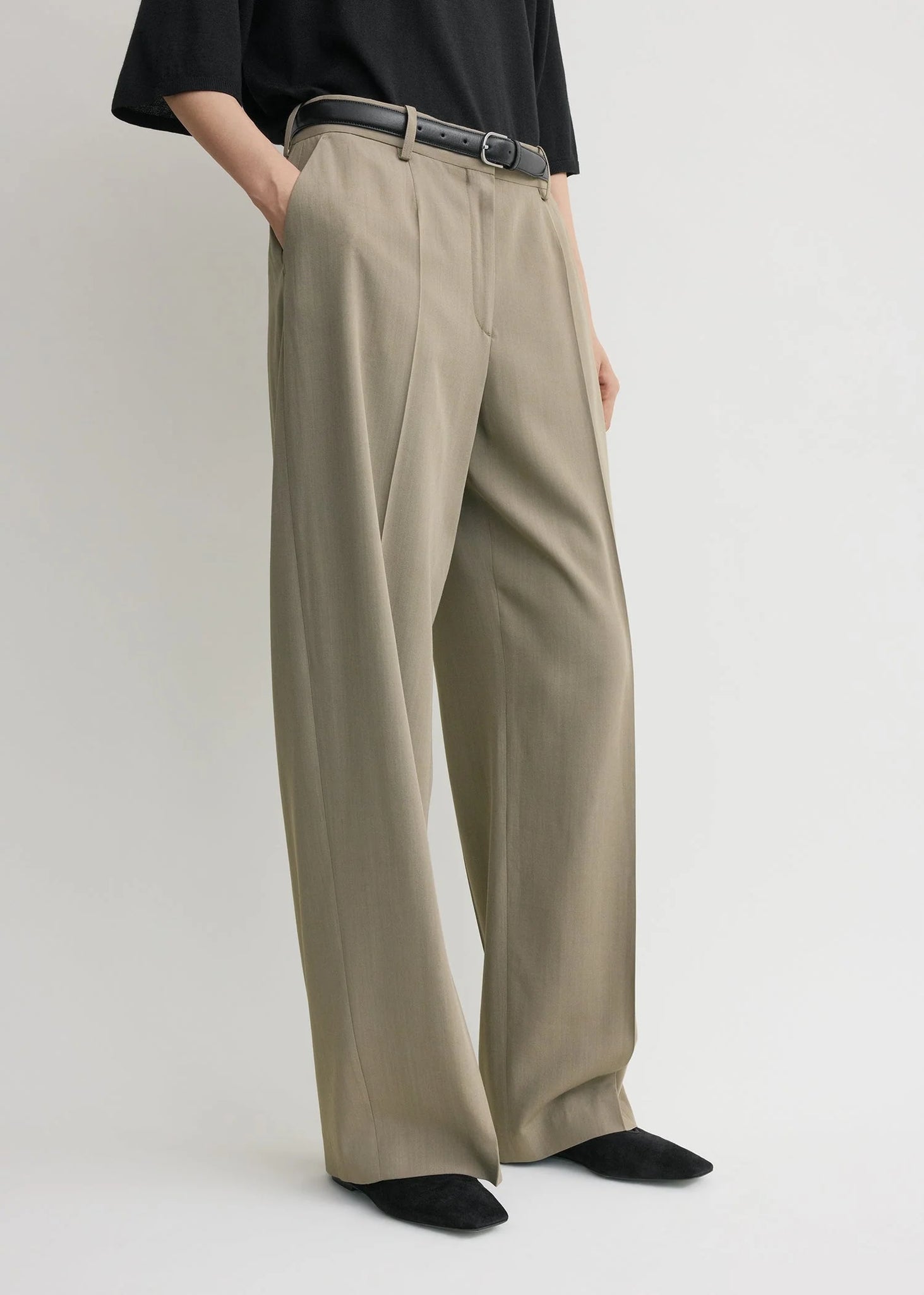 Back view of Wide Fluid Trousers in Taupe featuring a precise darting and clean front by TOTEME.