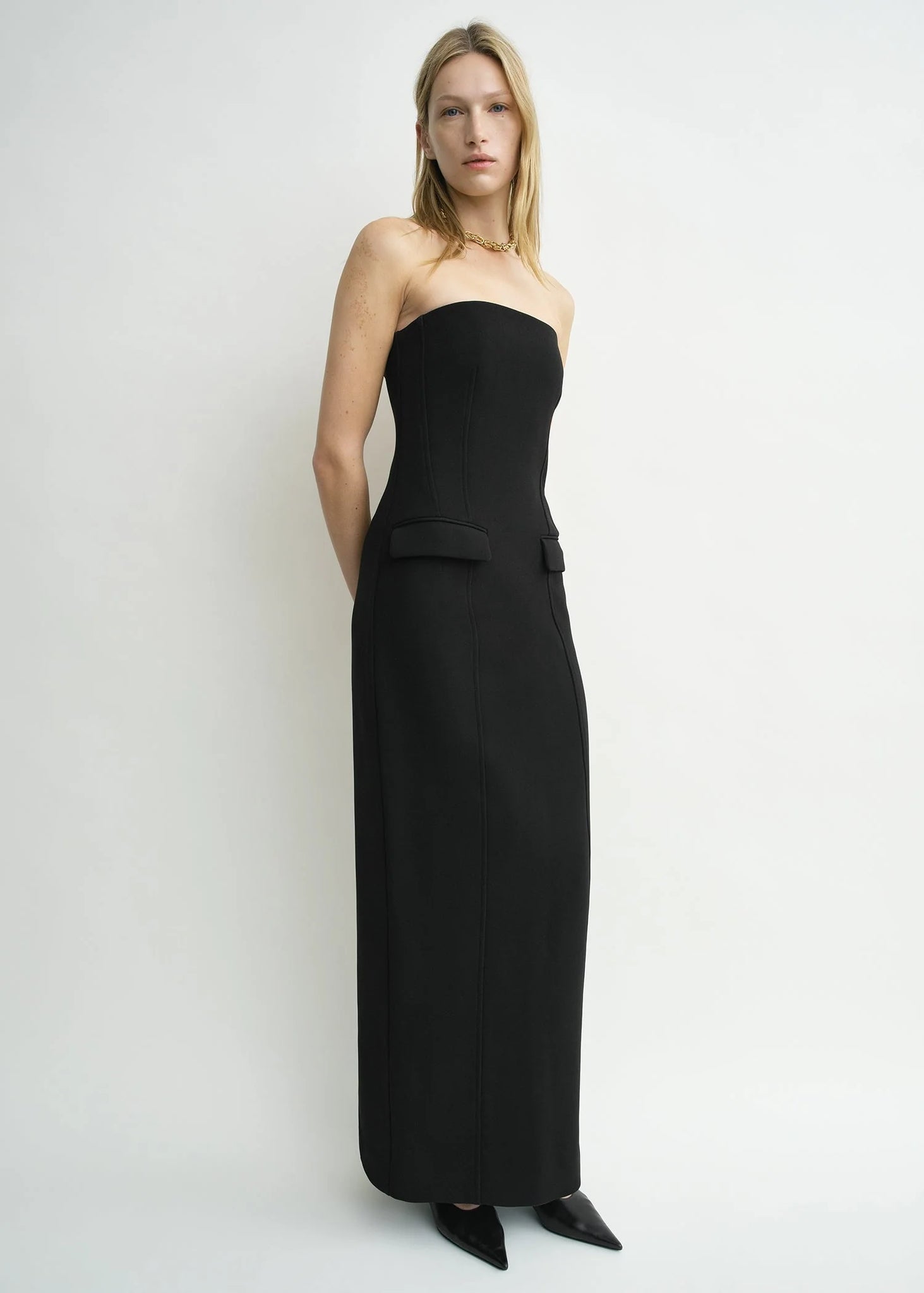 Chic front view of the TOTEME Strapless Pocket Dress in Black made from mid-weight bonded crepe.