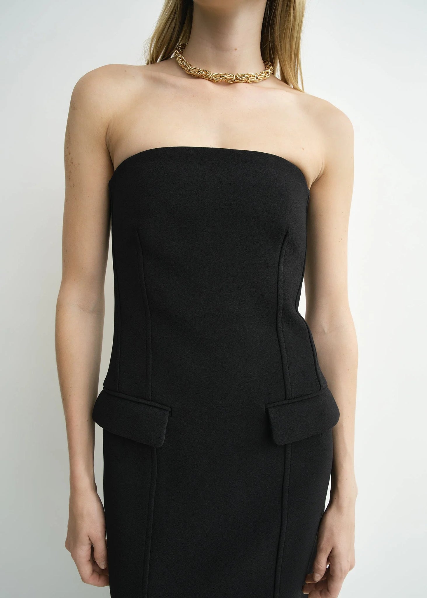 Full body view of the TOTEME Strapless Pocket Dress in Black, ideal for evening events.