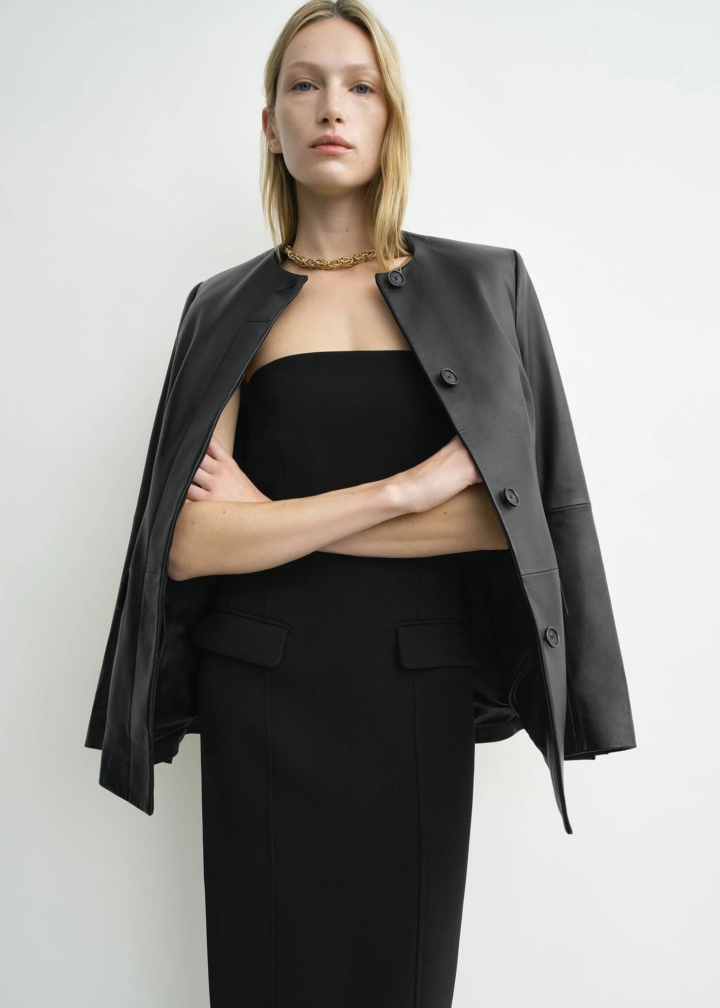 Close-up of the fabric texture of the TOTEME Strapless Pocket Dress in Black crafted from 100% recycled polyester.
