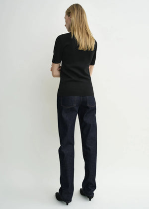 Close-up of the fabric texture of the Compact Knit Top in Black by TOTEME, highlighting its viscose and polyamide blend.